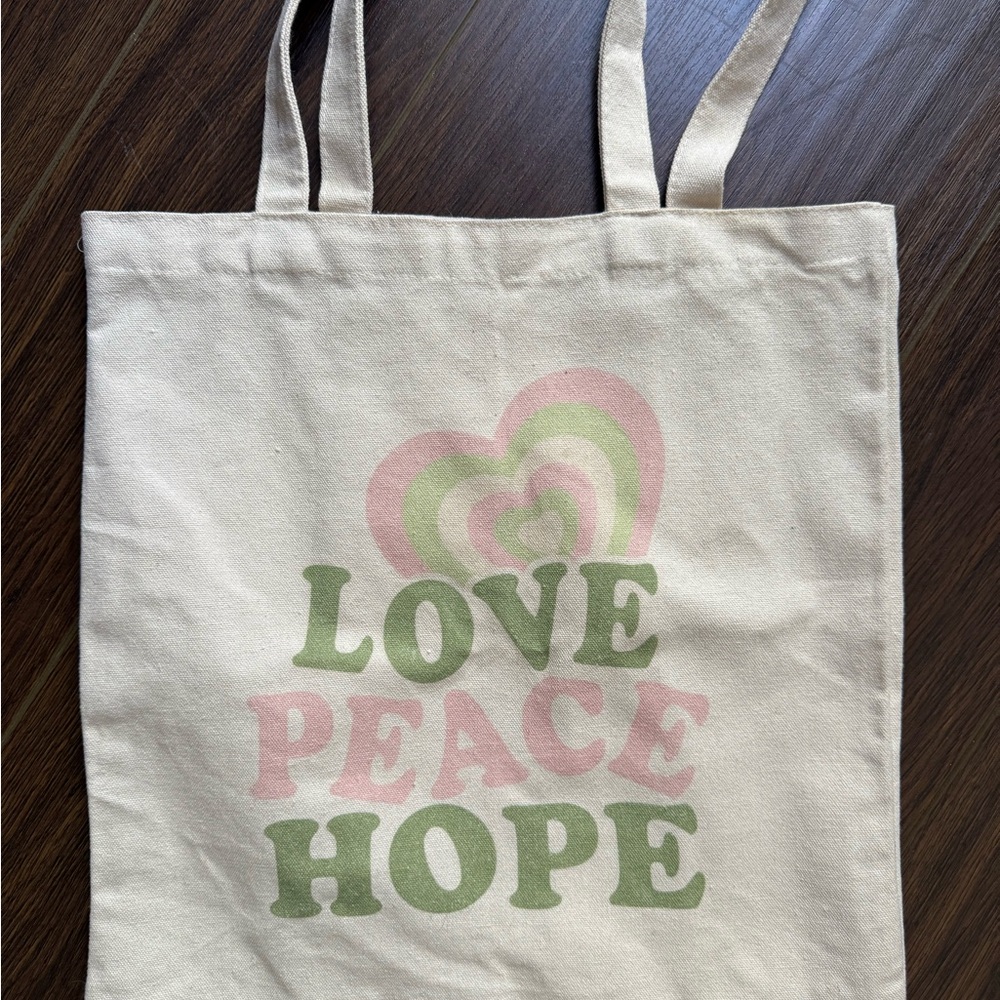 Cream canvas tote bag with "Love Peace Hope"